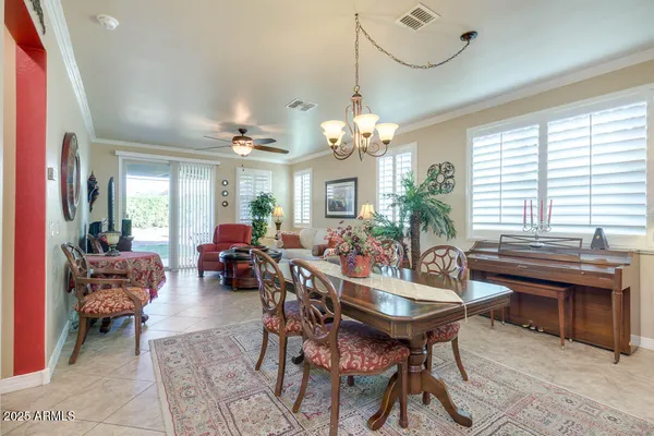 a view of a dining room with furniture and chandelier