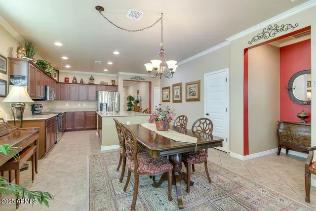 a view of a dining room with furniture and a chandelier