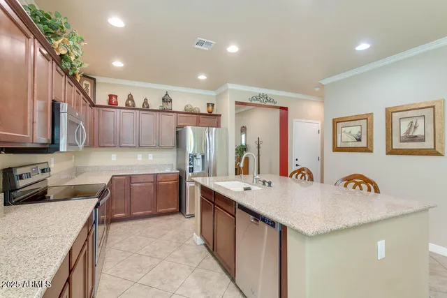 a kitchen with a refrigerator a sink and wooden cabinets