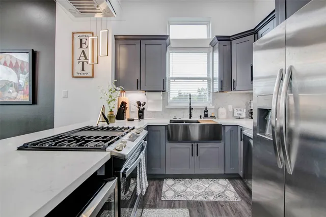 a kitchen with a stove a sink and a refrigerator