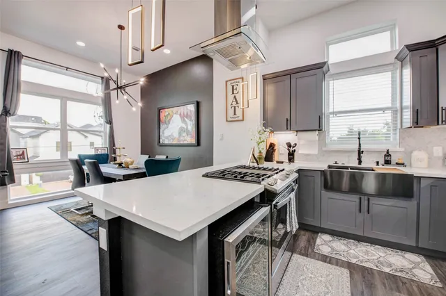 a kitchen with stainless steel appliances granite countertop a stove and a dining table