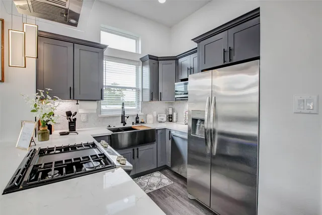 a kitchen with a refrigerator and a sink