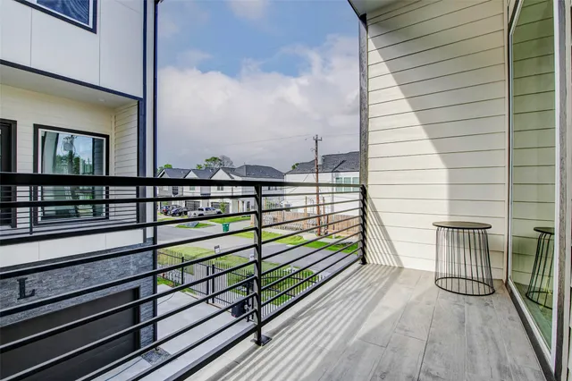 a view of a balcony with wooden fence