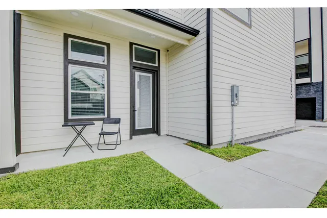 a view of backyard with a chair and potted plants