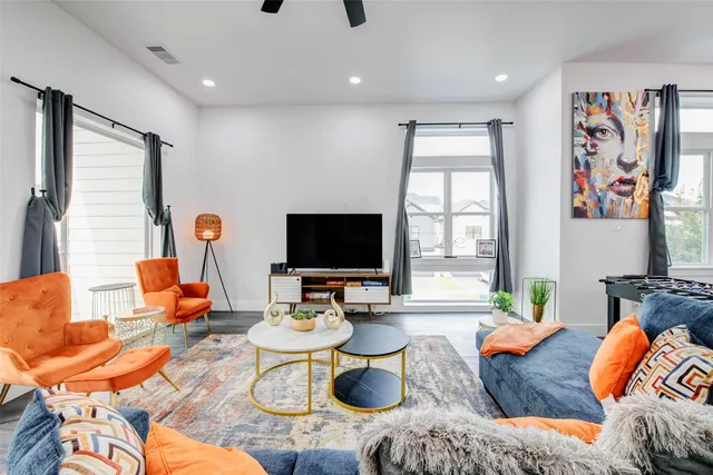 a living room with furniture and a large window