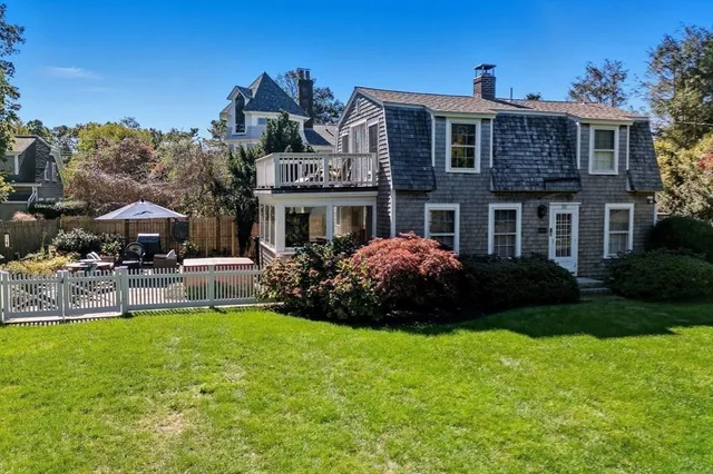 a front view of a house with a garden and plants