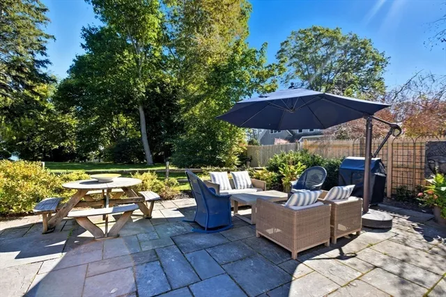 a view of a patio with couches and a umbrella