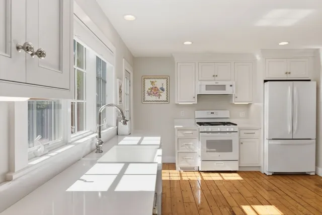 a kitchen with stainless steel appliances a refrigerator sink and stove