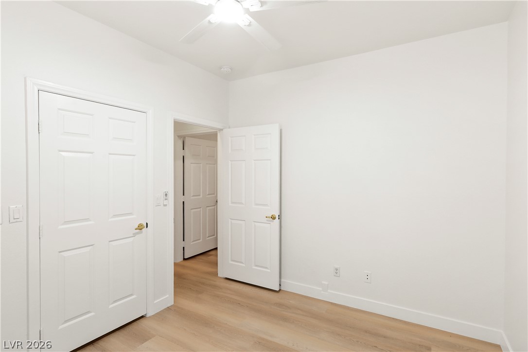 1134 Evening Ridge Street Henderson, NV 89052 - Photo 15 of 35 A quiet bedroom retreat features light wood flooring and a convenient ceiling fan for comfort.