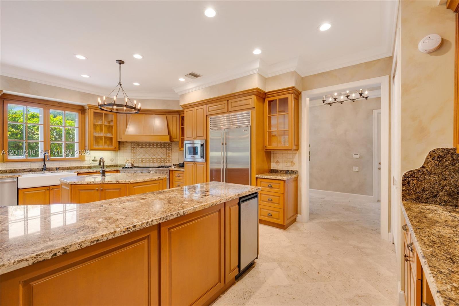 6905 Southwest 75th Avenue Miami, FL 33143 - Photo 19 of 85 a large kitchen with kitchen island a large counter top space a sink a refrigerator and cabinets