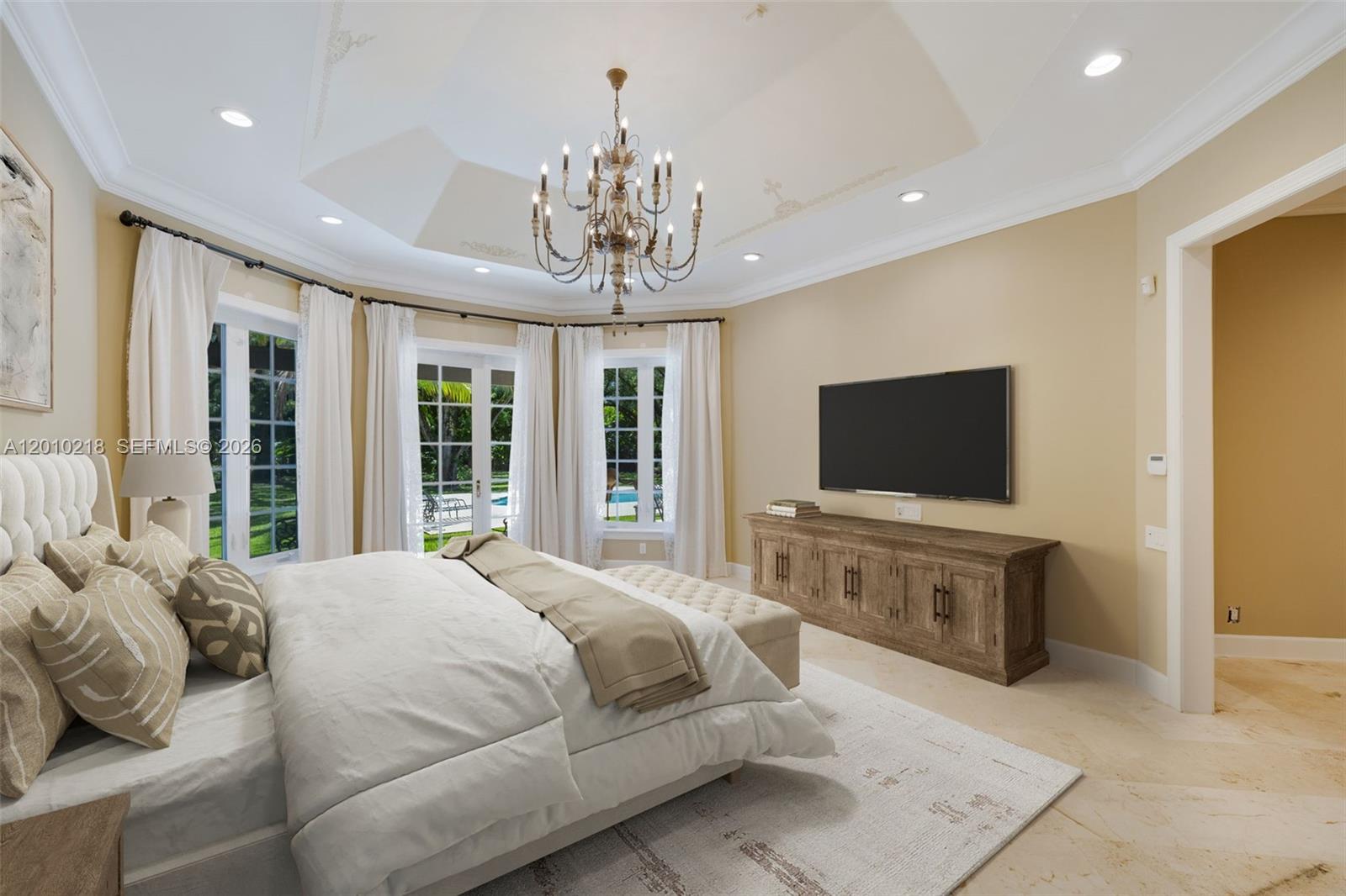 6905 Southwest 75th Avenue Miami, FL 33143 - Photo 4 of 85 a spacious bedroom with a large bed and a flat screen tv