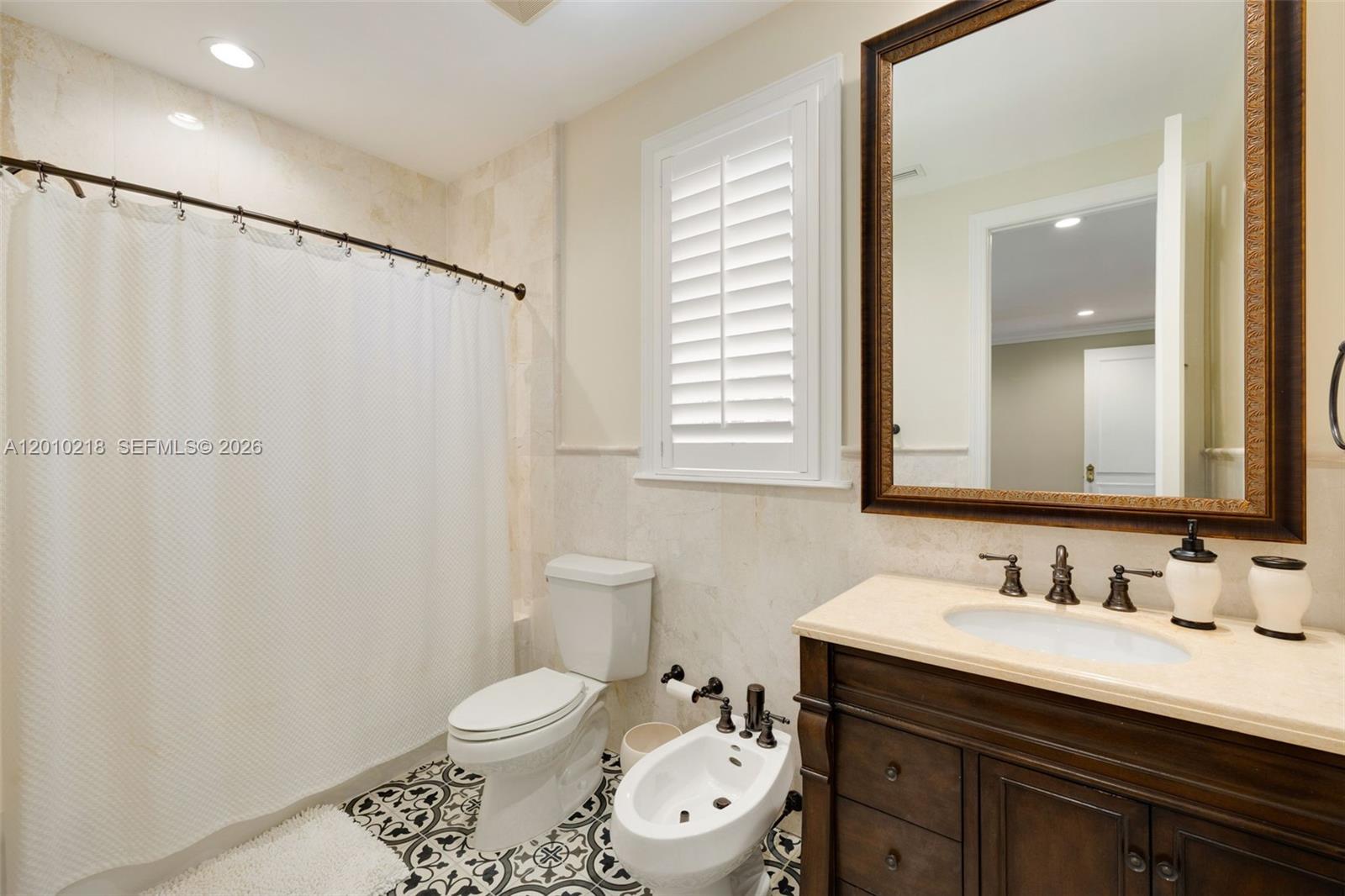 6905 Southwest 75th Avenue Miami, FL 33143 - Photo 52 of 85 a bathroom with a toilet a sink and a mirror