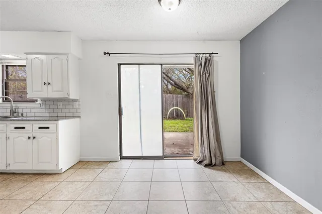 a view of a kitchen with cabinet and utility room