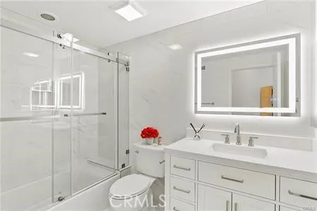 a bathroom with a sink vanity granite tub and shower