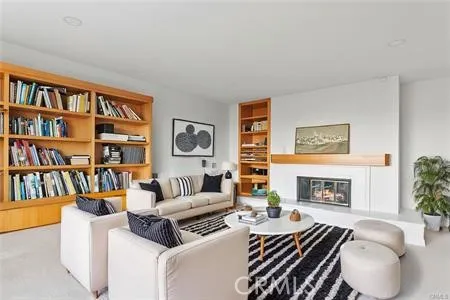 a living room with fireplace furniture and a book shelf