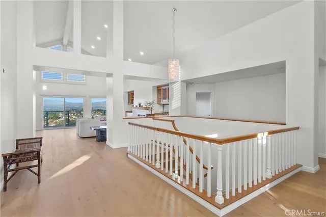 a view of a hallway with dining area and chandelier