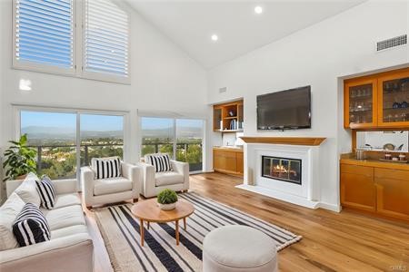 5 Argo Irvine, CA 92603 - Photo 4 of 24 a living room with furniture a fireplace and a flat screen tv