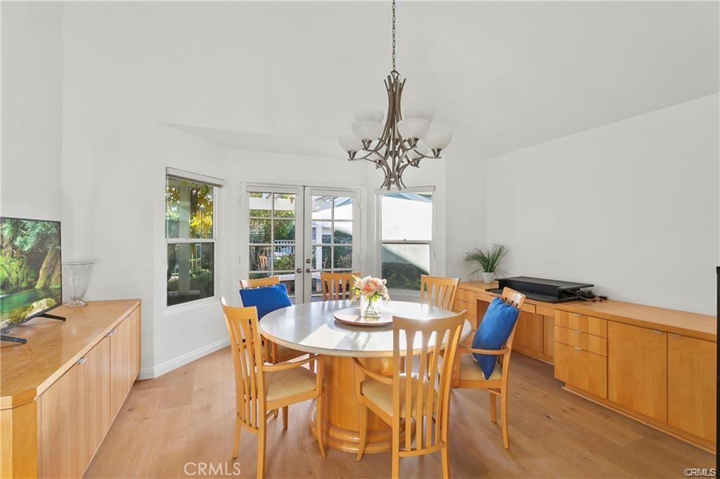 5 Argo Irvine, CA 92603 - Photo 6 of 24 a dining room with furniture a flat screen tv and a chandelier