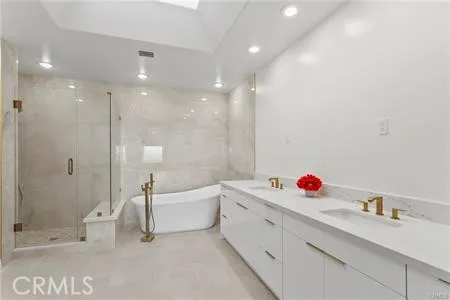 a bathroom with a tub sink a toilet and a shower