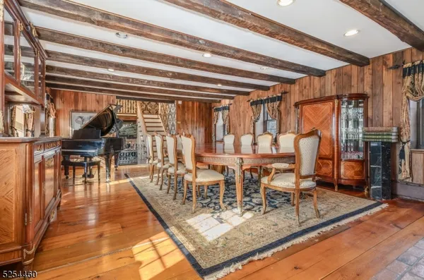 a view of a dining room with furniture a chandelier and wooden floor