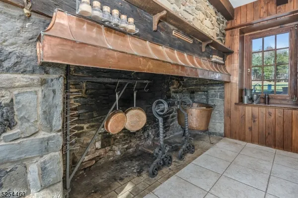 a kitchen with stainless steel appliances kitchen island granite countertop a table chairs and a refrigerator