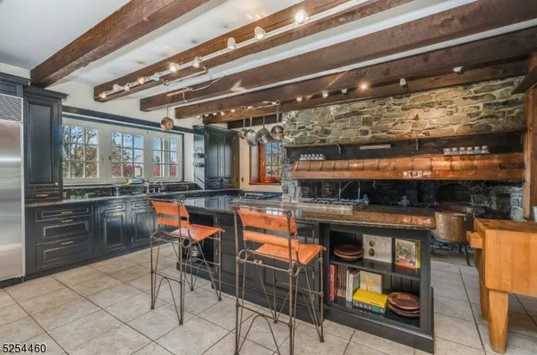 a dining room with furniture a chandelier and wooden floor