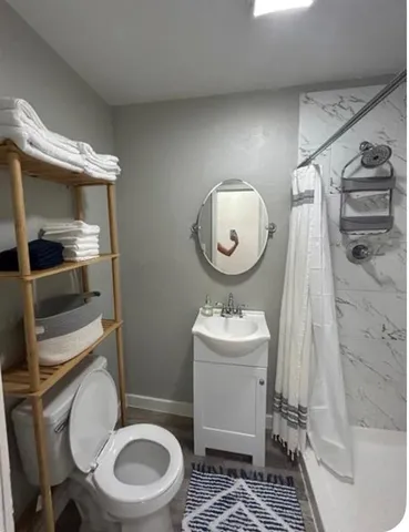 a bathroom with a sink mirror toilet and bathtub