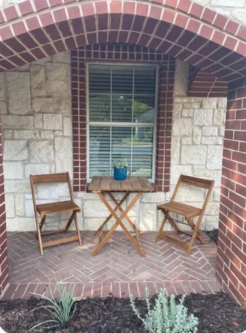 a view of a two chairs in a patio