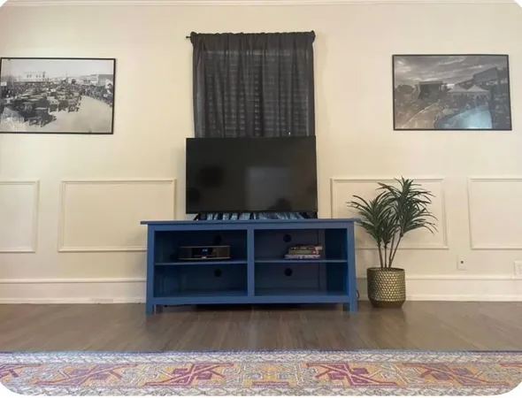 a kitchen with granite countertop white cabinets stainless steel appliances and a counter space