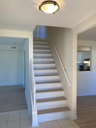 a view of entryway and hall with wooden floor