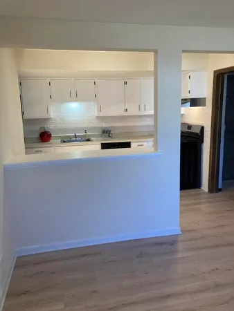 a kitchen with granite countertop a refrigerator and a stove