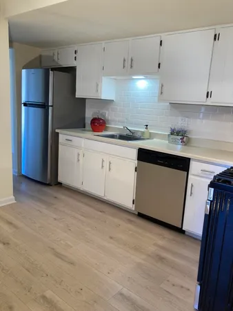 a kitchen with stainless steel appliances granite countertop a refrigerator sink and cabinets