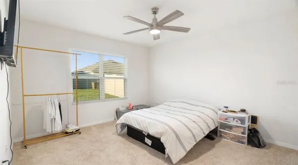 a bedroom with a bed and a window