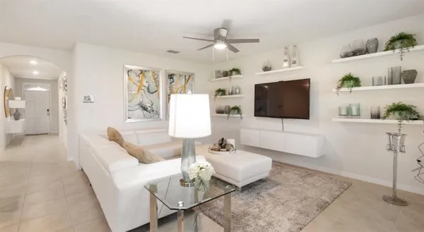 a living room with furniture and a flat screen tv