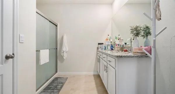 a bathroom with a double vanity sink and a mirror