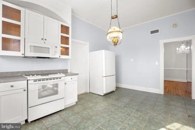 a view of a hallway with wooden floor and stairs