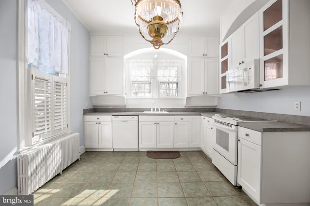 a view of a hallway with wooden floor and windows