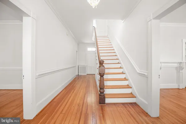 a view of a room with wooden floor and windows