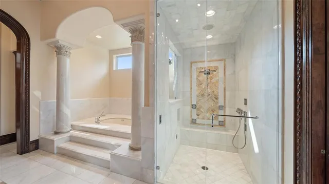 a bathroom with a glass shower door