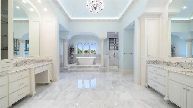 a spacious bathroom with a granite countertop sink a mirror and a shower