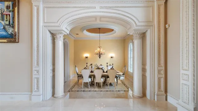 a dining room with chandelier and outdoor view