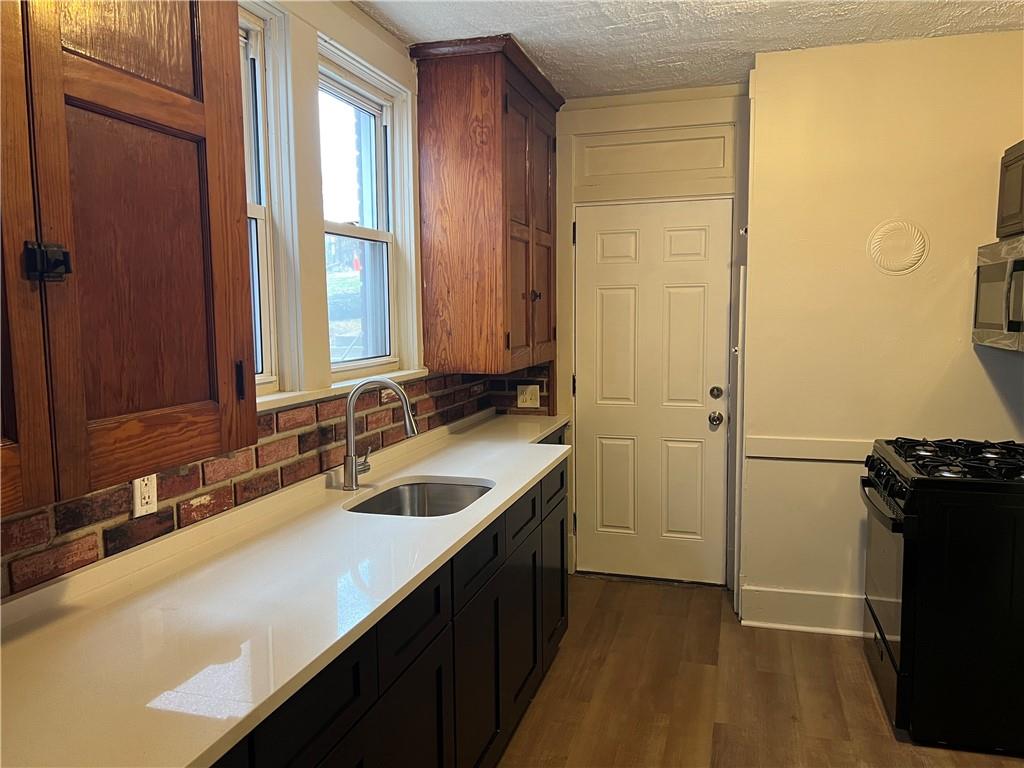 216 Suncrest Street Pittsburgh, PA 15210 - Photo 13 of 32 a bathroom with a sink and a mirror