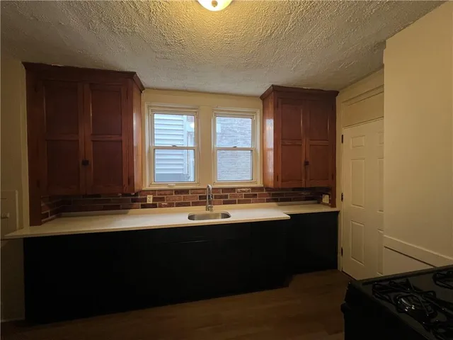 a kitchen with a sink and a window