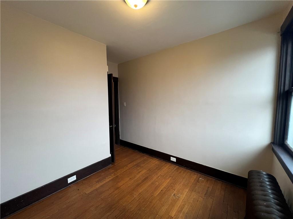 216 Suncrest Street Pittsburgh, PA 15210 - Photo 18 of 32 a view of an empty room and wooden floor
