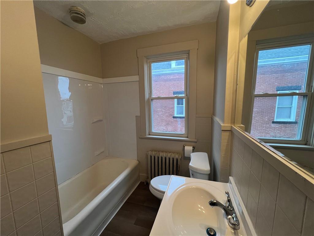 216 Suncrest Street Pittsburgh, PA 15210 - Photo 25 of 32 a bathroom with a tub sink and mirror