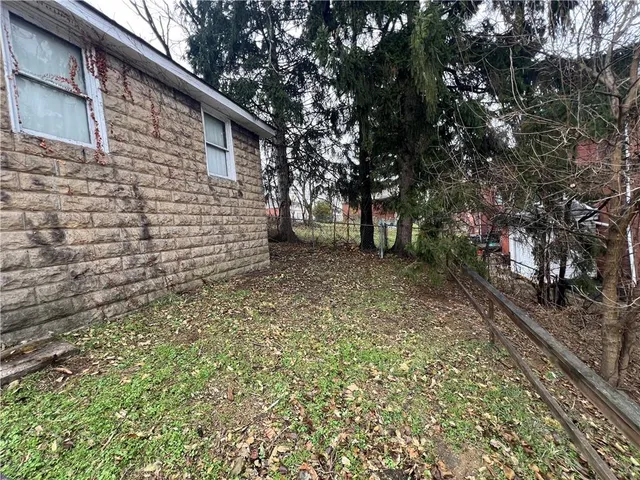 a view of a backyard with large trees