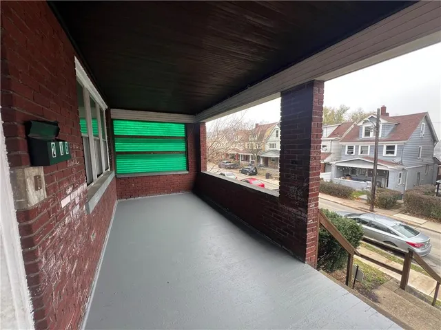 a view of a porch with furniture and a gate