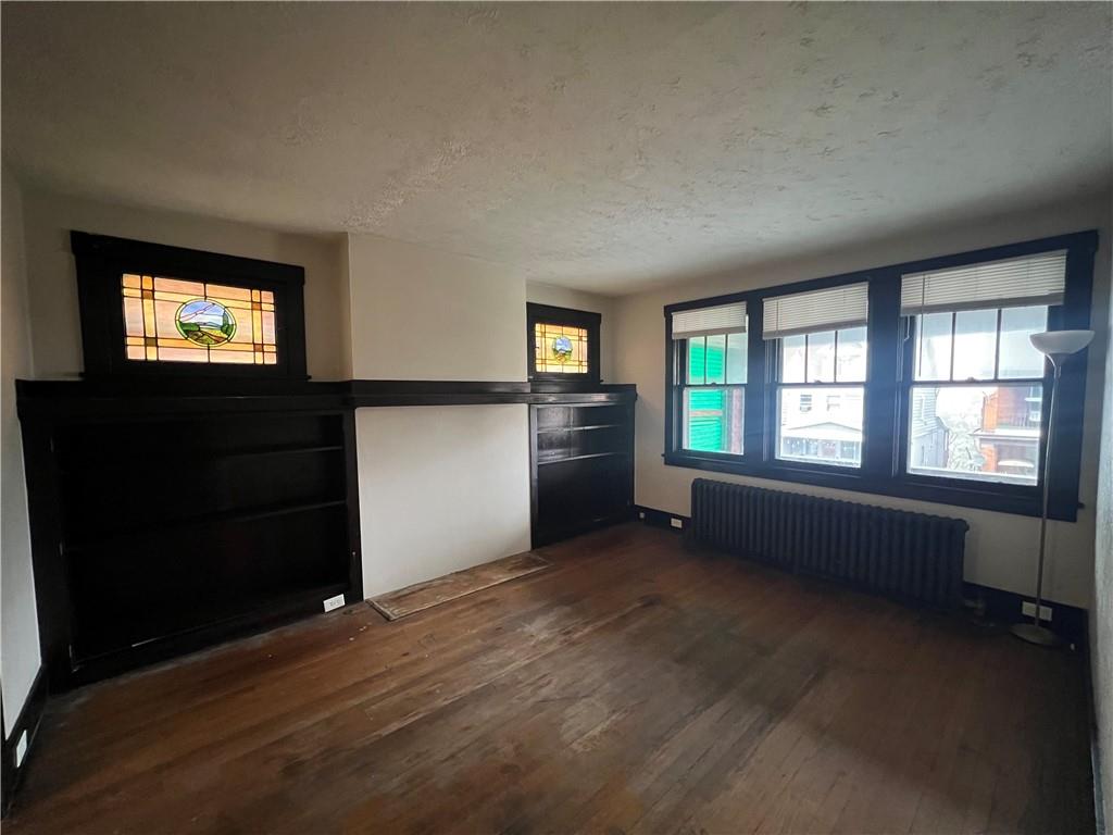 216 Suncrest Street Pittsburgh, PA 15210 - Photo 8 of 32 wooden floor in an empty room with a window