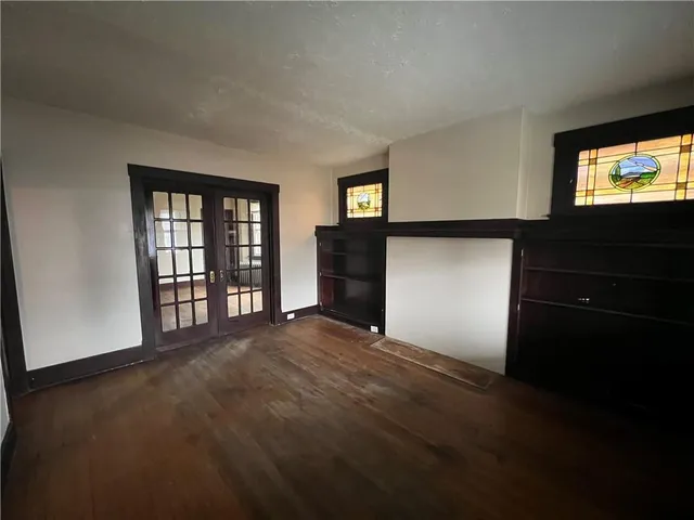 a view of empty room with a fireplace