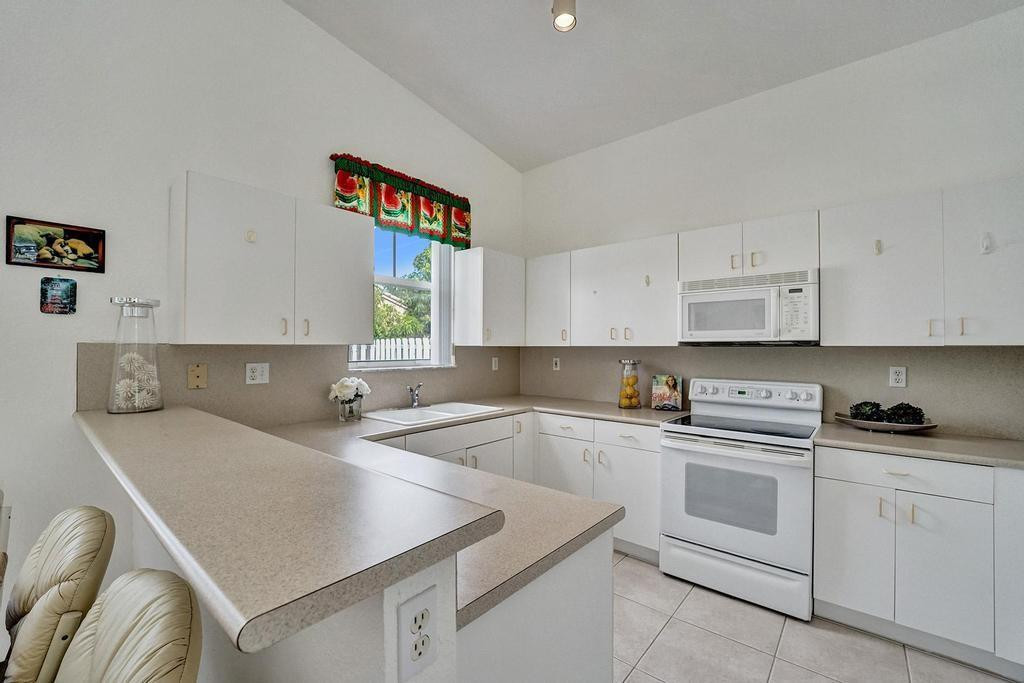 13175 Southwest 24th Street Miramar, FL 33027 - Photo 14 of 66 Spacious kitchen with white appliances.